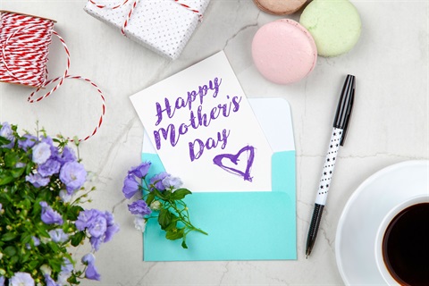 Canva - Happy Mothers Day Card Beside Pen, Macaroons, Flowers, and Box Near Coffee Cup With Saucer.jpg